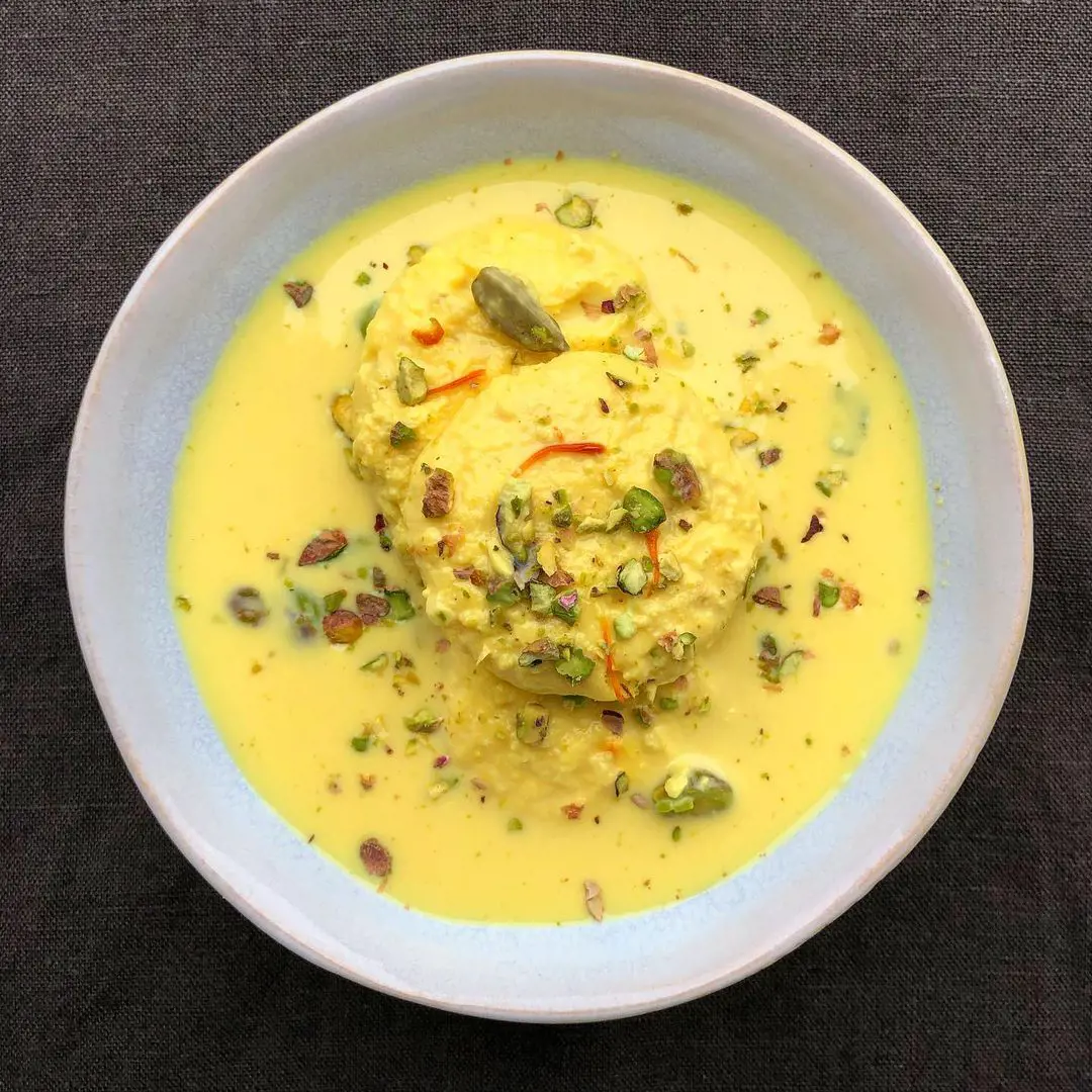 Ras malai is dessert served with dry nuts like almonds and pistachio in a saffron-infused milk