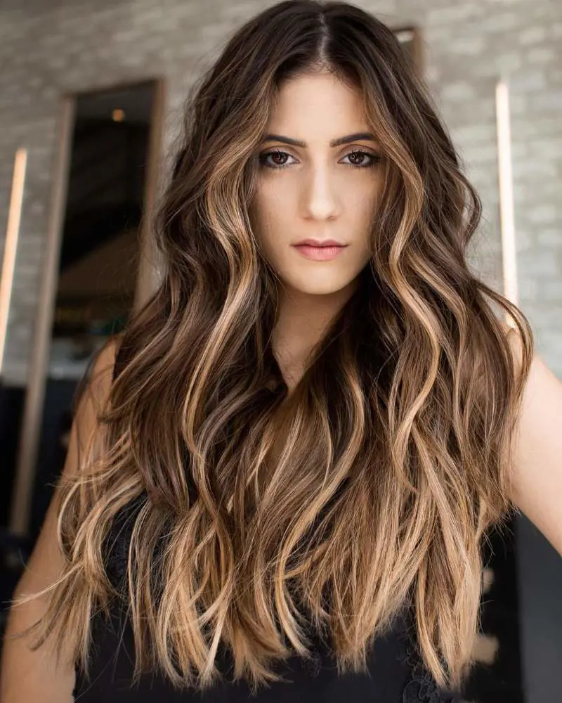 Golden blonde highlights creating a unique movement of color on long-layered hair