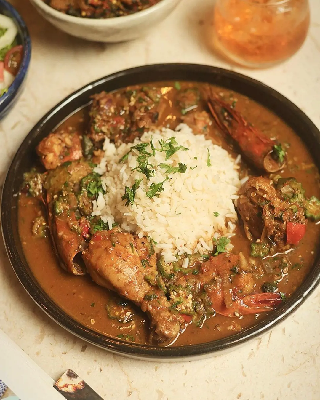 Chicken and okra slow cooked in a gumbo is often paired with rice