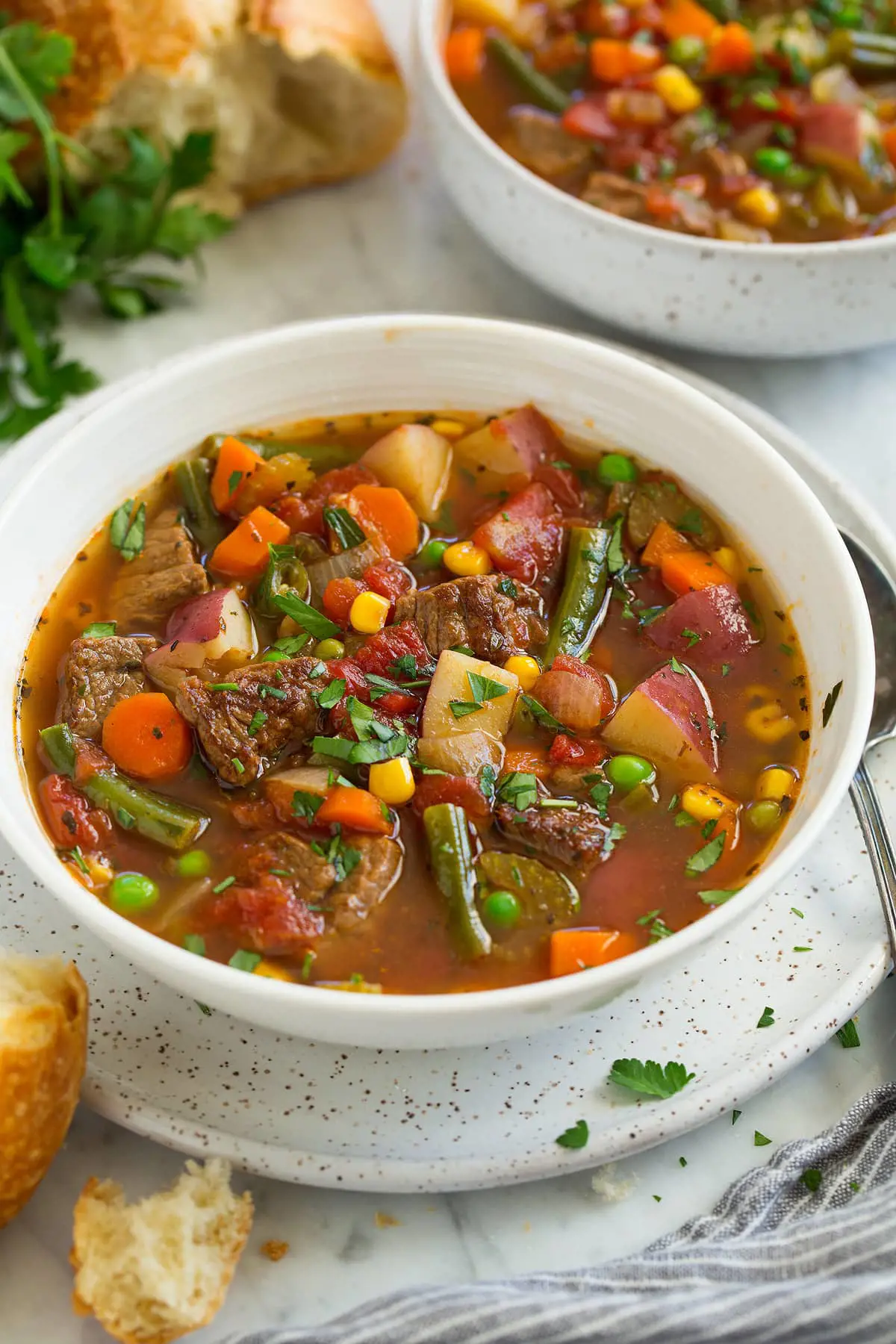 Beef soup is supported by vegetables like squash, okra and tomatoes