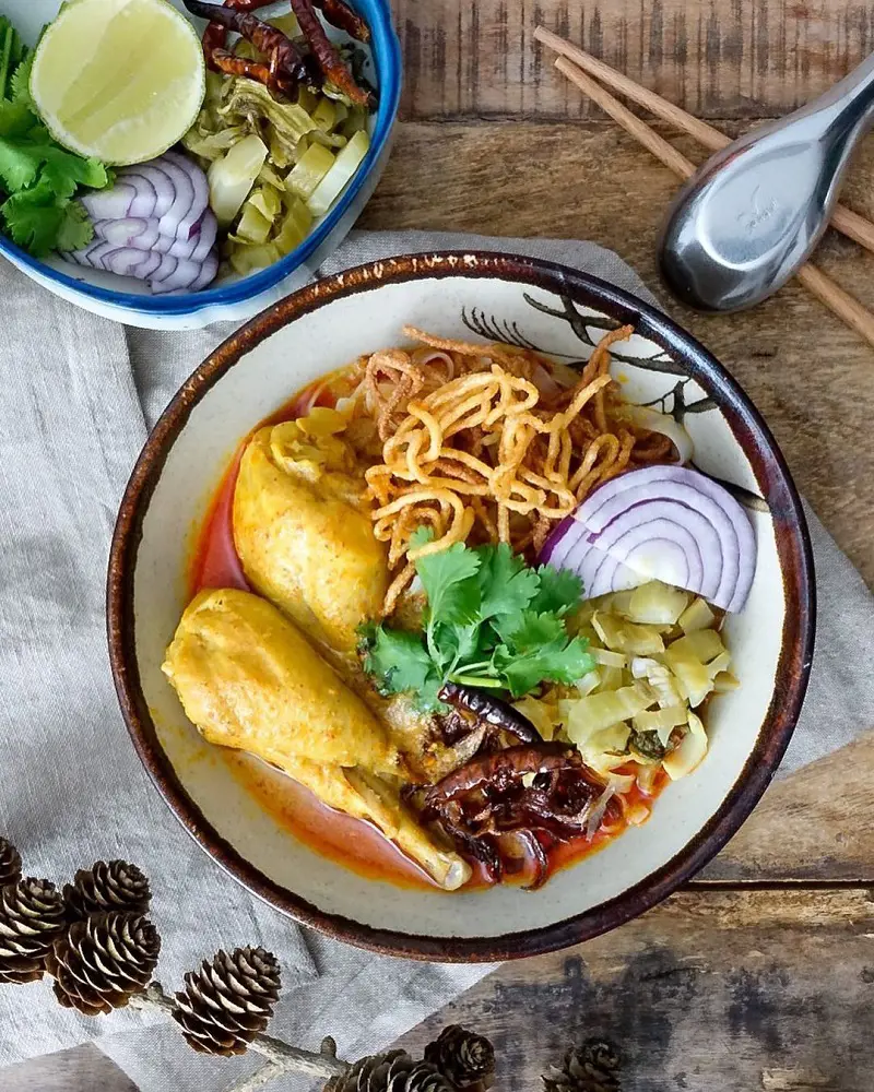 A northern Thai style dish Khao Soui is a savory and spicy curry with noodles and fresh toppings.