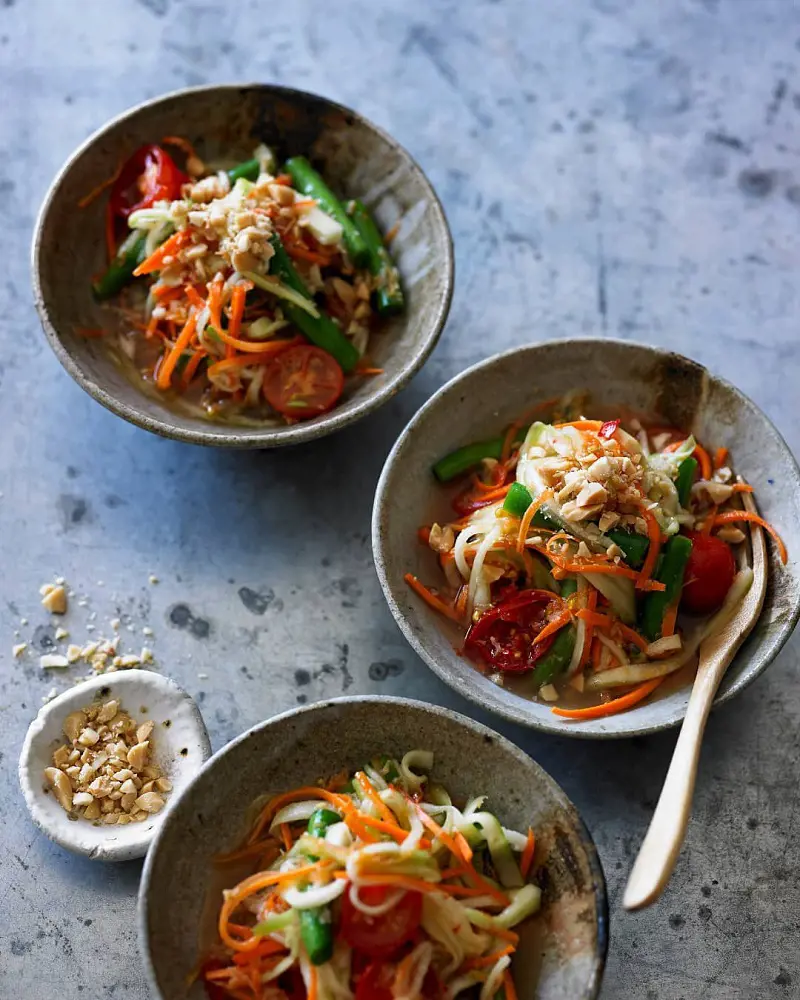 Som Tam or green papaya salad means pound the sour is originally from Laos and Northeastern Thailand. 