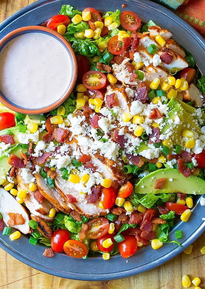 Mexican Grilled Chicken Salad by Sommer Collier which is loaded with vegetables and topped with tomato dressing