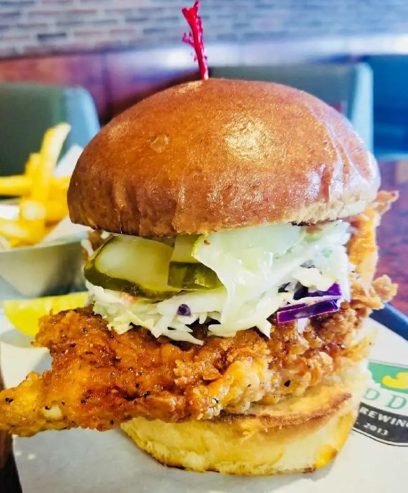 Nashville-Style Hot Chicken Sandwich with a crispy, spicy chicken breast, pickles, and coleslaw on a toasted sweet bun