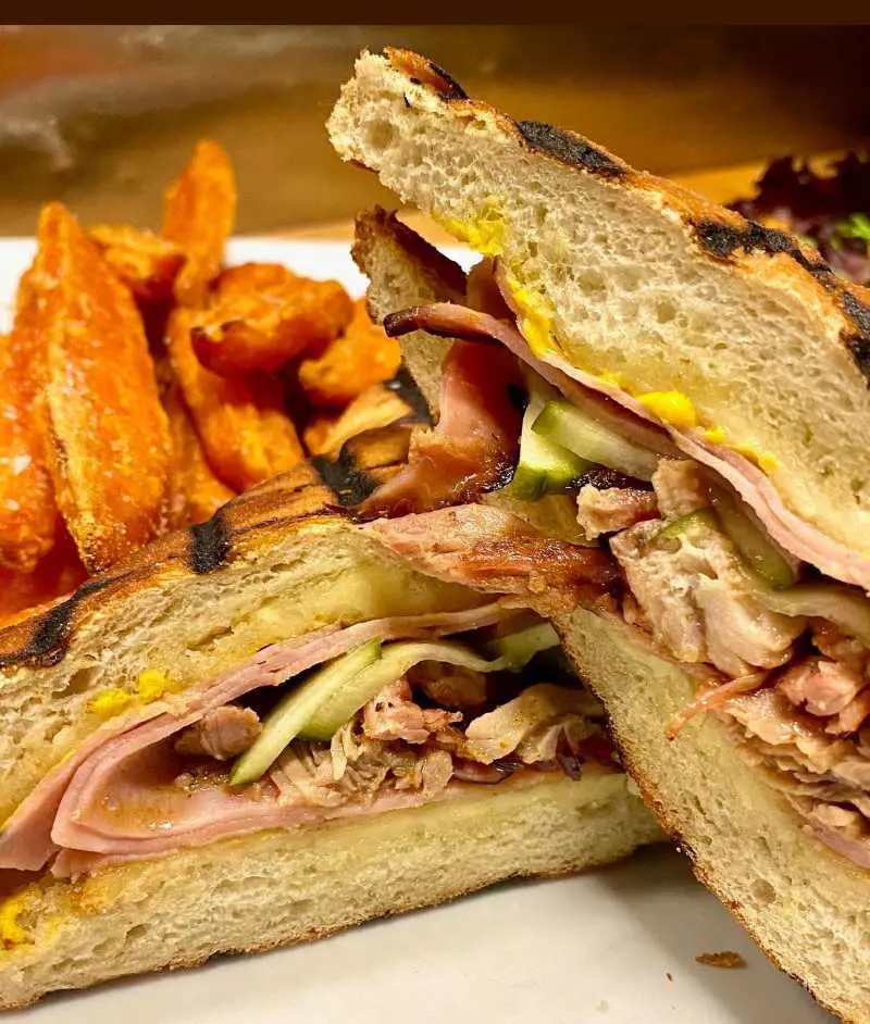 Cuban Sandwich with pulled pork, black' forest ham, Swiss cheese, pickles & yellow mustard