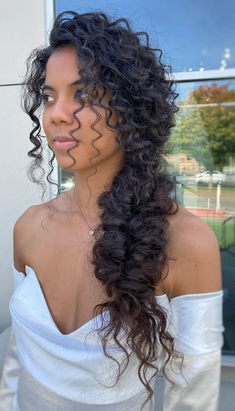 The texture in this Side-Swept Low Ponytail hairstyle looking stunning in this natural curl hair